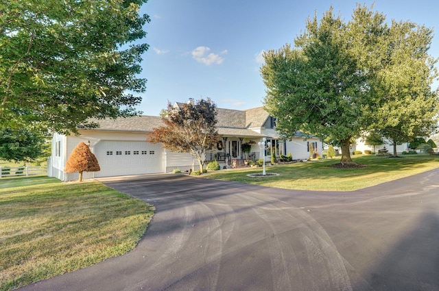 view of front of property with a garage and a front lawn