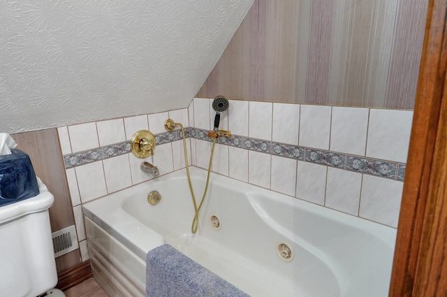 1568 Glossip Ave, Highlandville, MO 65669 - full bath featuring a whirlpool tub, toilet, and a textured ceiling