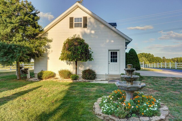 view of side of home featuring a yard