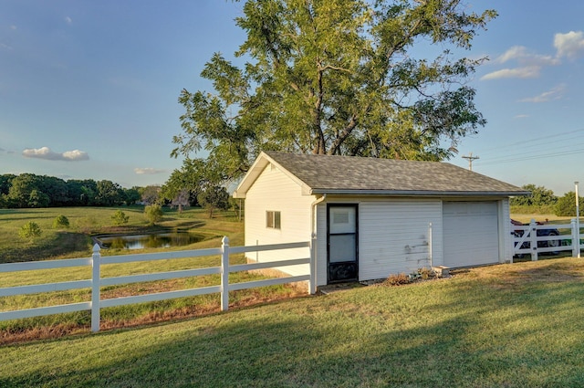 view of outdoor structure featuring a yard and a water view