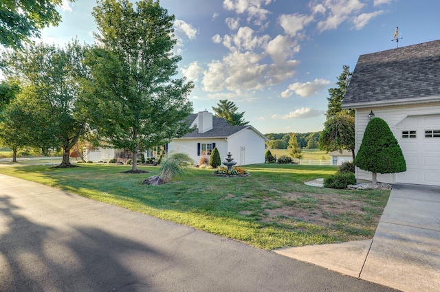 view of home's exterior with a yard and a garage