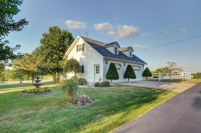 view of side of property with a lawn and a garage