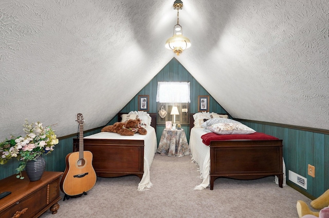 carpeted bedroom with a textured ceiling and vaulted ceiling