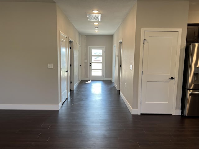 hallway with dark hardwood / wood-style flooring