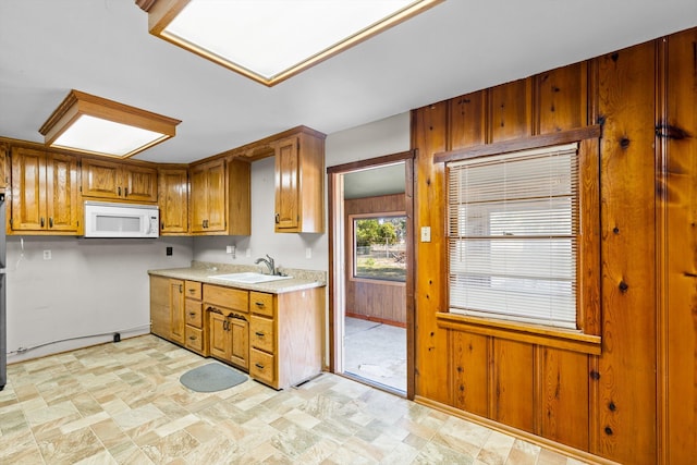 kitchen with wooden walls and sink