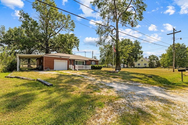 view of yard featuring a carport and a garage