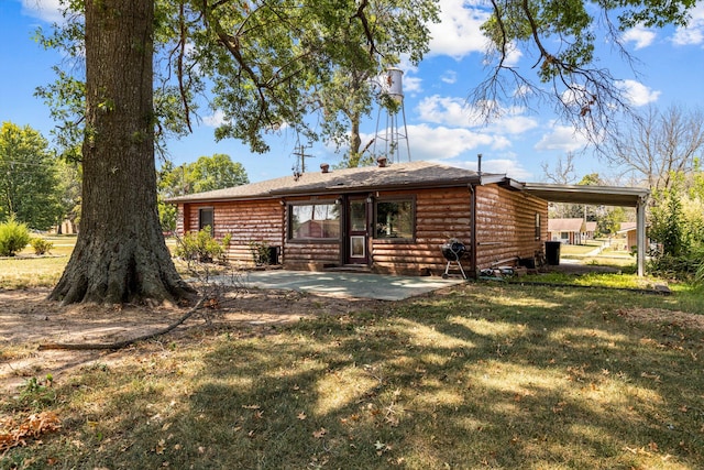 rear view of property with a yard and a patio