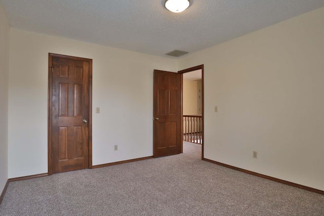 unfurnished bedroom with carpet and a textured ceiling