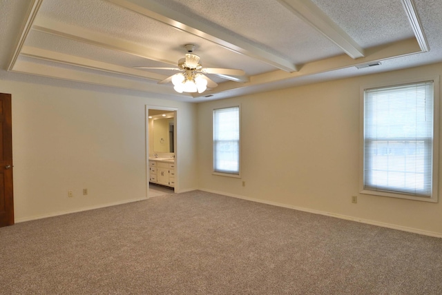 spare room with light colored carpet, beam ceiling, a textured ceiling, and ceiling fan