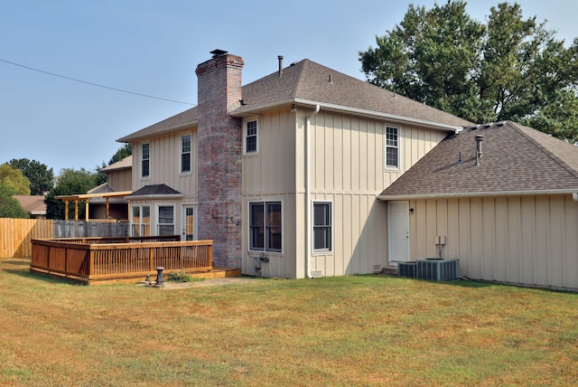 back of property featuring a yard and a deck