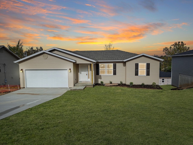 ranch-style house featuring a yard and a garage