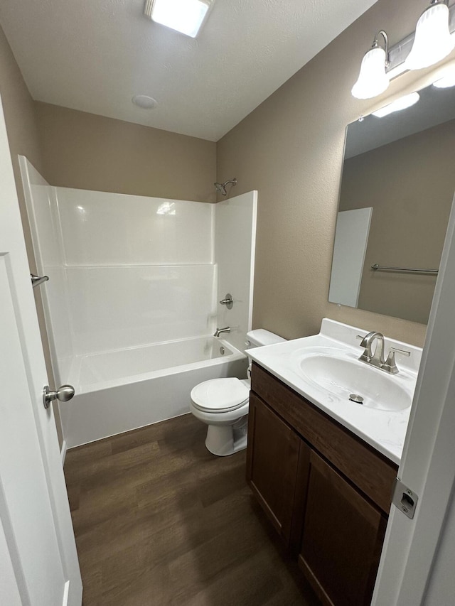 full bathroom featuring vanity, toilet, shower / bathing tub combination, and hardwood / wood-style flooring