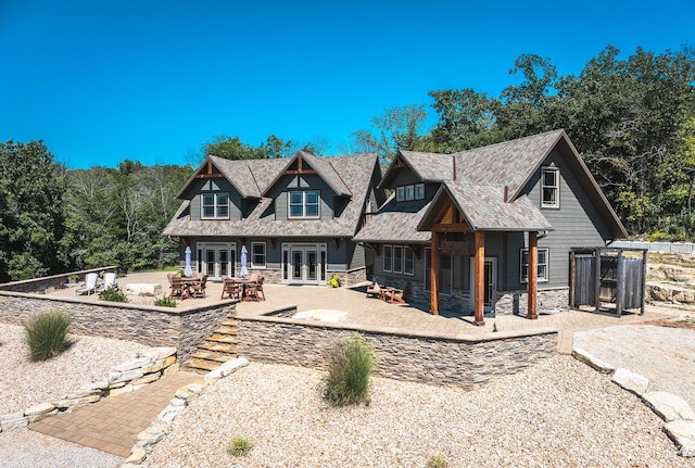 1326 Bald Eagle Dr, Galena, MO 65656 - back of property with a patio area, stone siding, an outdoor fire pit, and french doors