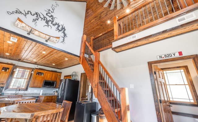 1326 Bald Eagle Dr, Galena, MO 65656 - kitchen with brown cabinets, appliances with stainless steel finishes, a towering ceiling, and visible vents