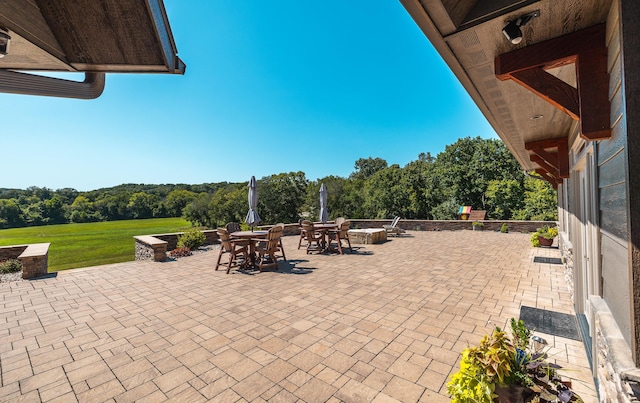 1326 Bald Eagle Dr, Galena, MO 65656 - view of patio / terrace with an outdoor fire pit, a view of trees, and outdoor dining area
