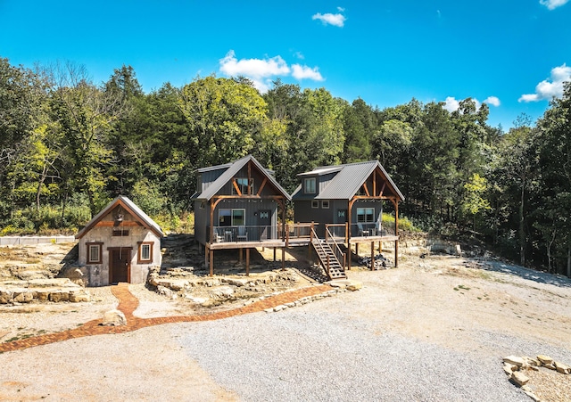 1326 Bald Eagle Dr, Galena, MO 65656 - view of front of house featuring an outbuilding, a wooden deck, stairway, a forest view, and gravel driveway