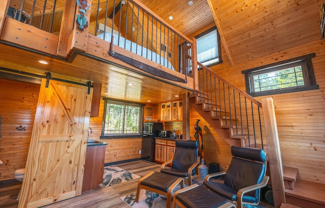 1326 Bald Eagle Dr, Galena, MO 65656 - living room featuring stairway, wood finished floors, wooden walls, a high ceiling, and recessed lighting