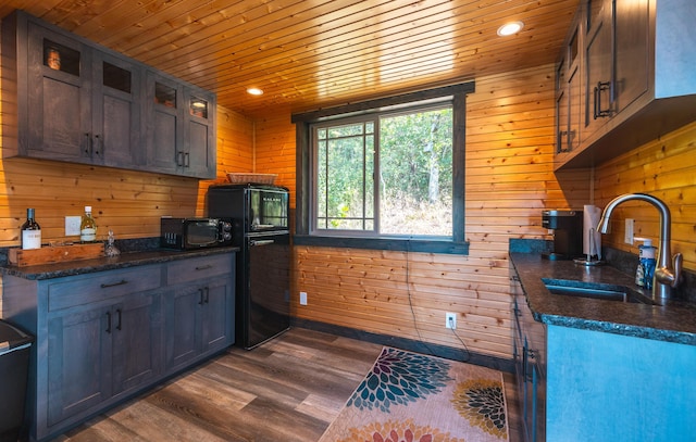 1326 Bald Eagle Dr, Galena, MO 65656 - kitchen with wooden walls, wooden ceiling, a sink, black microwave, and dark wood-style flooring