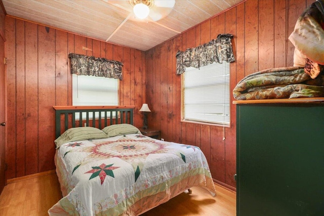 bedroom with hardwood / wood-style flooring, wood ceiling, and wood walls