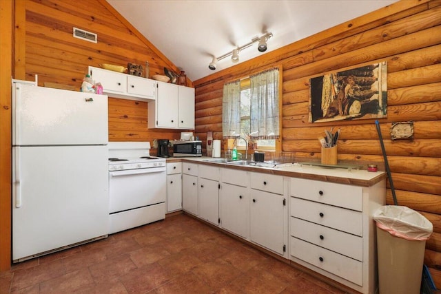 kitchen featuring lofted ceiling, white appliances, sink, white cabinetry, and tile counters