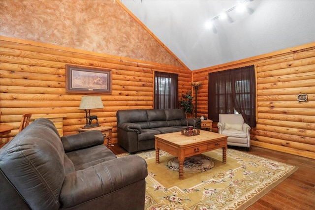 living room with high vaulted ceiling and hardwood / wood-style flooring