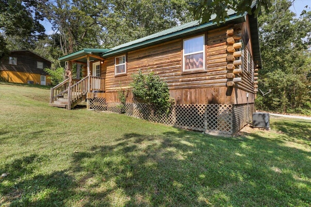 view of front of property with a front lawn and central AC unit