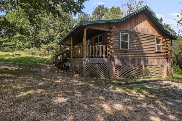 view of property exterior with a deck and a lawn