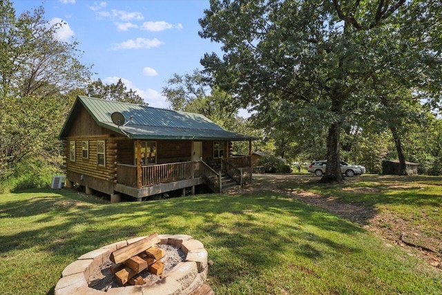 view of yard featuring a deck, central AC unit, and a fire pit