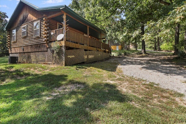 view of property exterior with a deck, central air condition unit, and a lawn