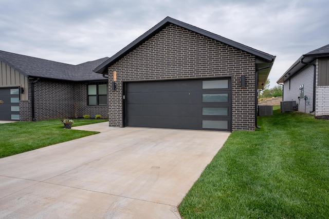 5955 S Farm Rd 163 203B, Springfield, MO 65810 - view of front of property with brick siding, a front yard, central air condition unit, and concrete driveway