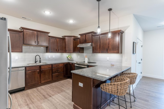 5955 S Farm Rd 163 203B, Springfield, MO 65810 - kitchen with stainless steel appliances, a sink, visible vents, light wood-style floors, and under cabinet range hood