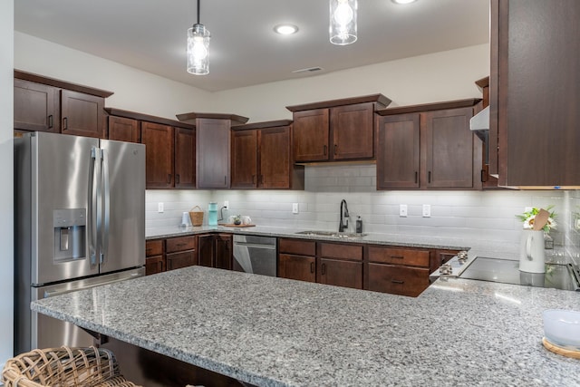 5955 S Farm Rd 163 203B, Springfield, MO 65810 - kitchen with light stone counters, a sink, pendant lighting, stainless steel appliances, and a peninsula