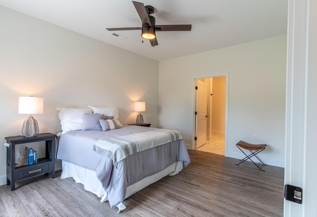 5955 S Farm Rd 163 203B, Springfield, MO 65810 - bedroom featuring baseboards, wood finished floors, visible vents, and ceiling fan