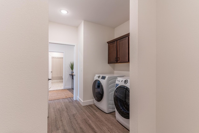 5955 S Farm Rd 163 203B, Springfield, MO 65810 - washroom with washing machine and dryer, baseboards, recessed lighting, wood finished floors, and cabinet space