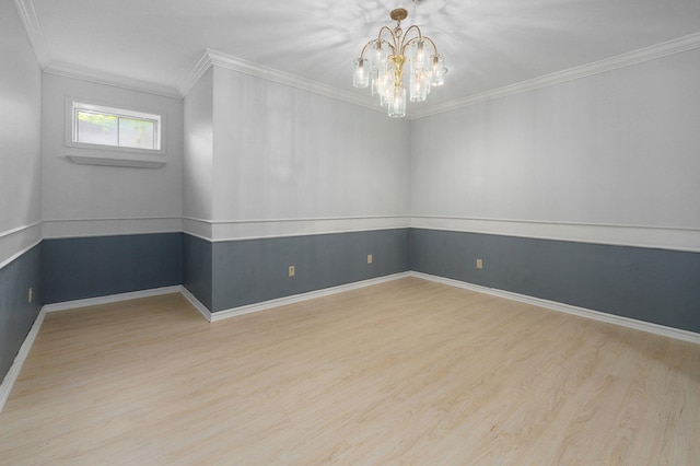 empty room featuring light hardwood / wood-style floors, crown molding, and a chandelier