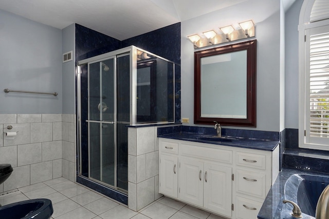 bathroom with tile patterned floors, tile walls, vanity, and plus walk in shower