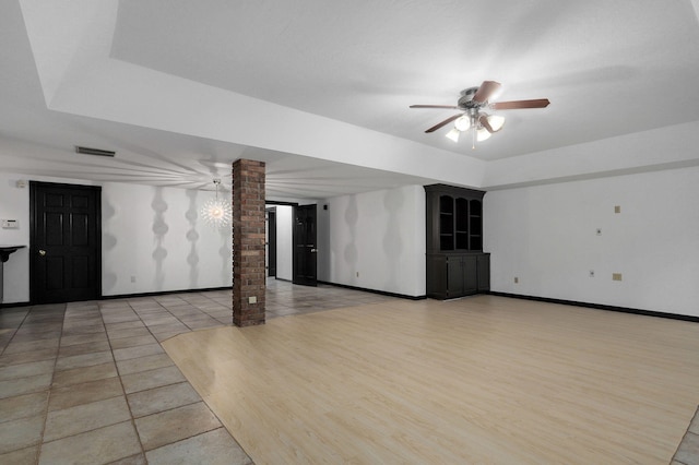 basement with ceiling fan and light hardwood / wood-style flooring