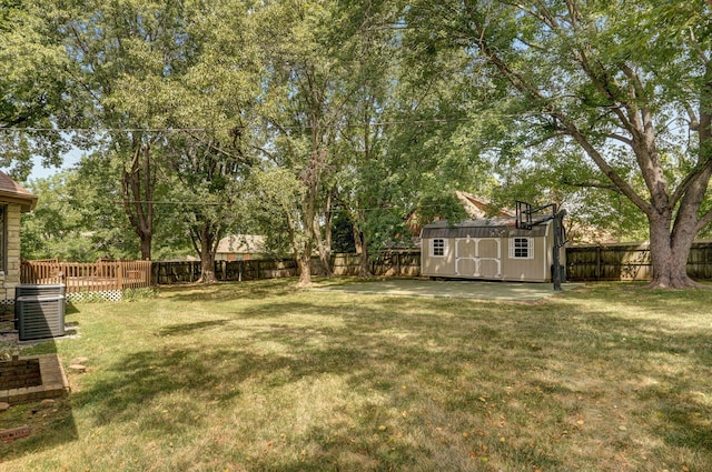 view of yard featuring central AC unit and a shed