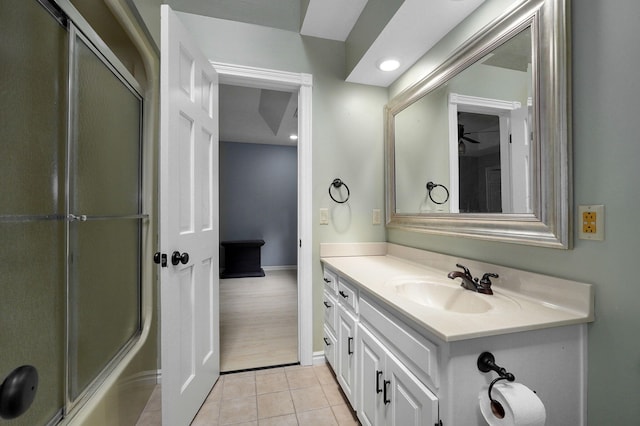 bathroom featuring tile patterned flooring, shower / bath combination with glass door, and vanity