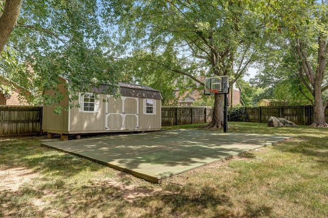 view of basketball court with a yard