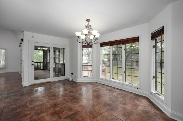 unfurnished dining area with a notable chandelier