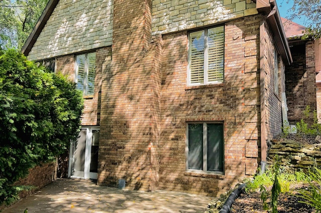 view of side of property with a patio