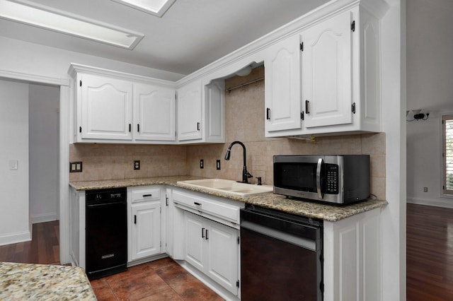 kitchen with black dishwasher, sink, and white cabinetry