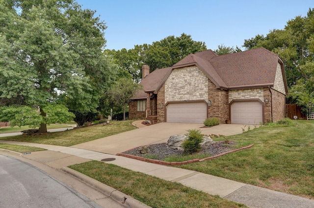 view of front of home featuring a garage and a front yard