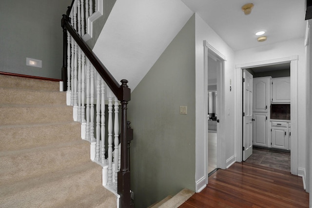 staircase with wood-type flooring