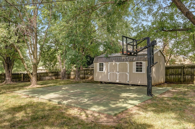 view of basketball court with a lawn