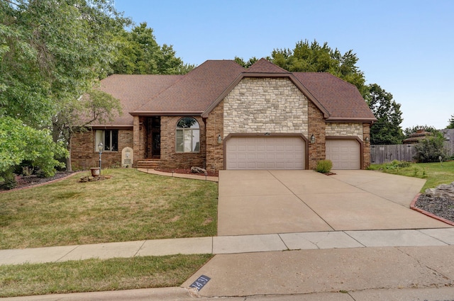 view of front of home with a garage and a front lawn