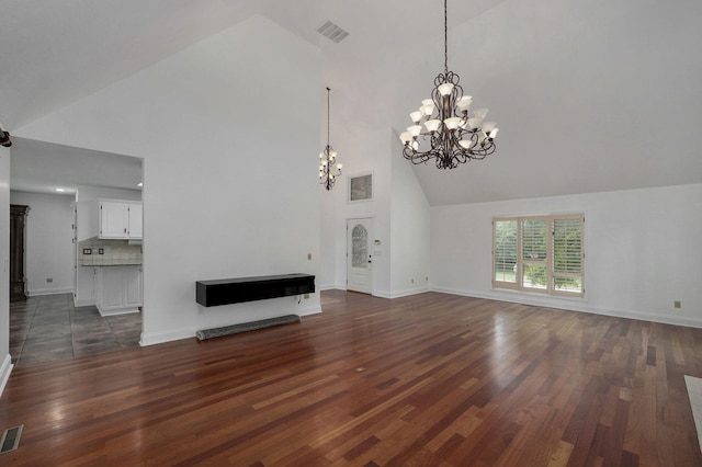 unfurnished living room with a chandelier, dark hardwood / wood-style flooring, and high vaulted ceiling