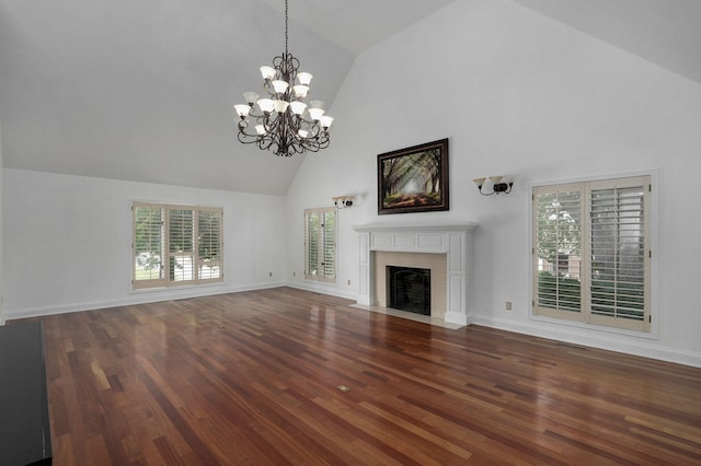 unfurnished living room featuring high vaulted ceiling, a chandelier, and wood-type flooring