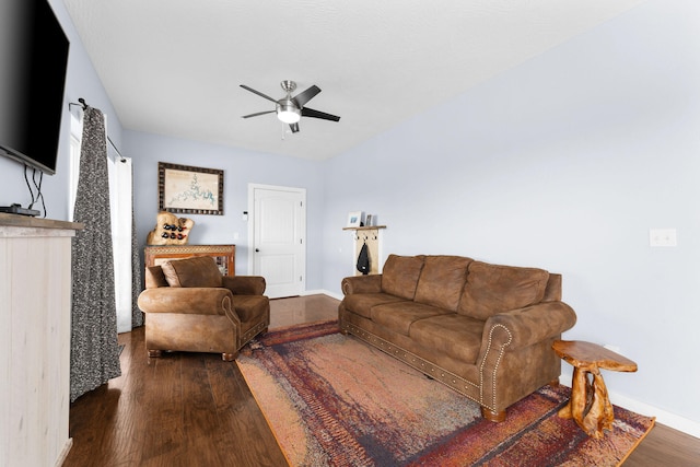 living room with dark hardwood / wood-style flooring and ceiling fan